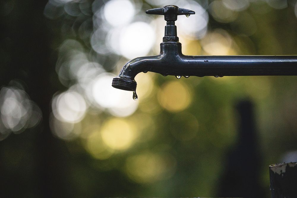 Outdoor tap faucet drips with water. Original public domain image from Wikimedia Commons
