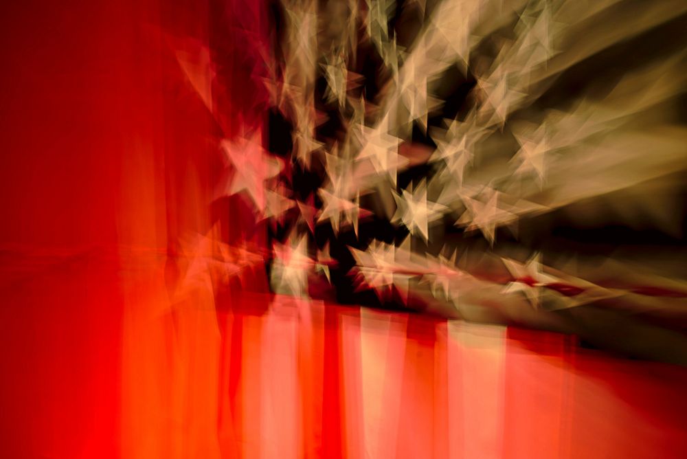 Blurry view of the stars and stripes on an American flag. Original public domain image from Wikimedia Commons
