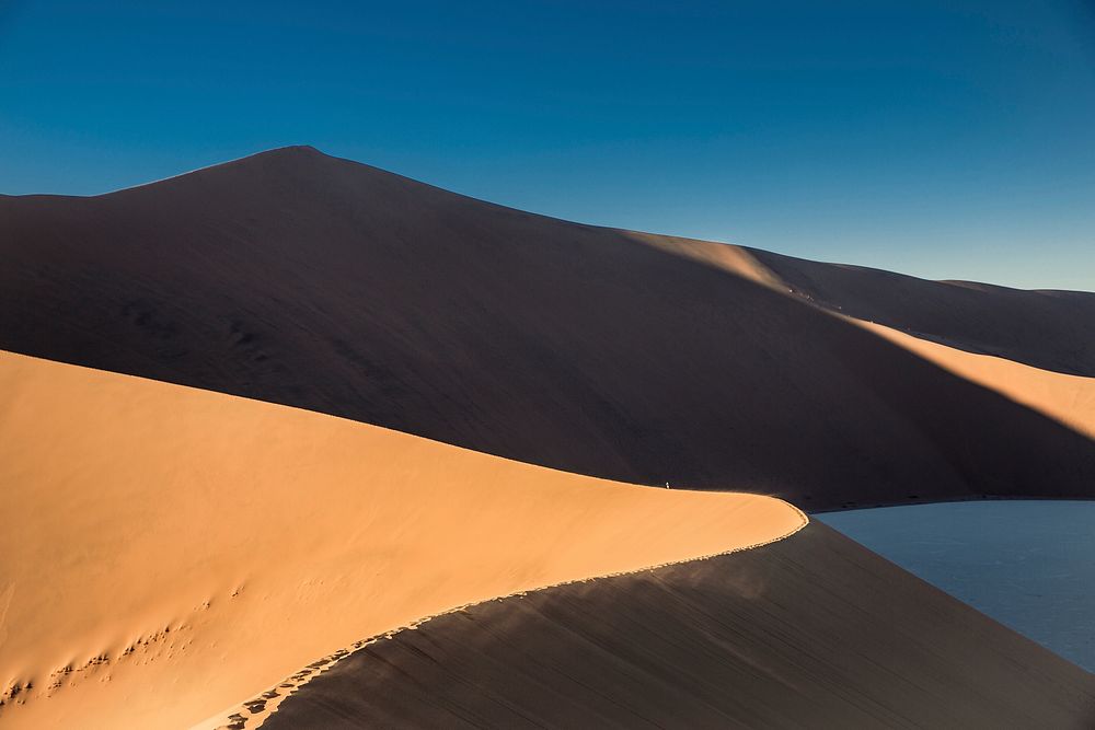 Sand dunes and ridges in the desert at sundown. Original public domain image from Wikimedia Commons