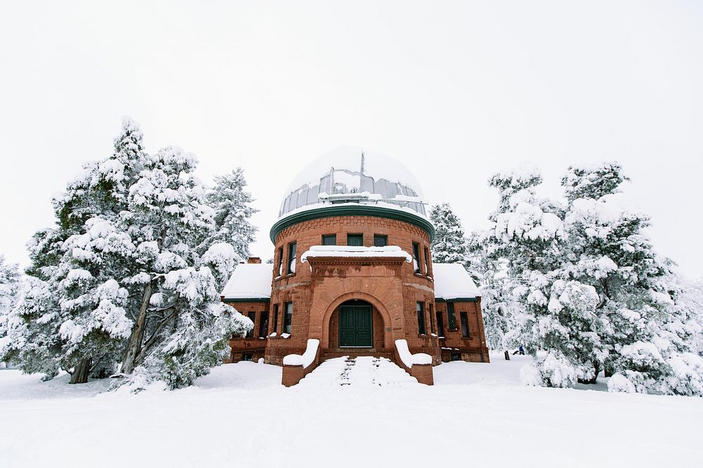 A building in the snow surrounded by wintery trees. Original public domain image from Wikimedia Commons