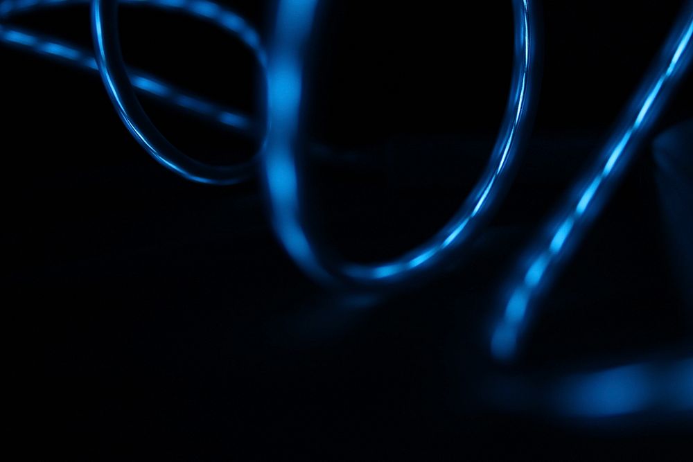Blue light reflected in the surface of glossy swirling wires. Original public domain image from Wikimedia Commons