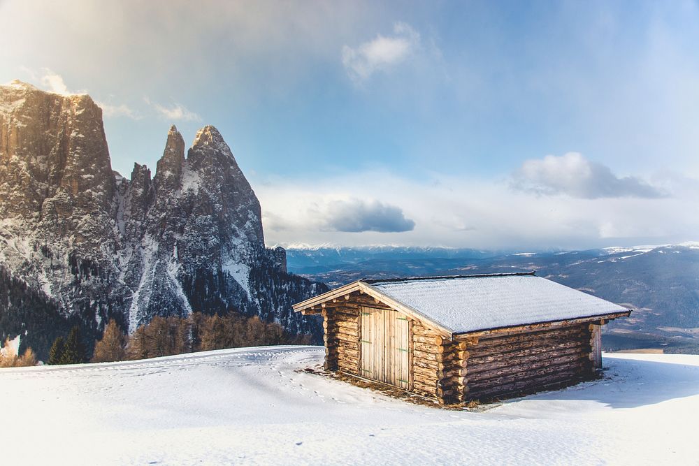 Wooden house covered in snow. Original public domain image from Wikimedia Commons