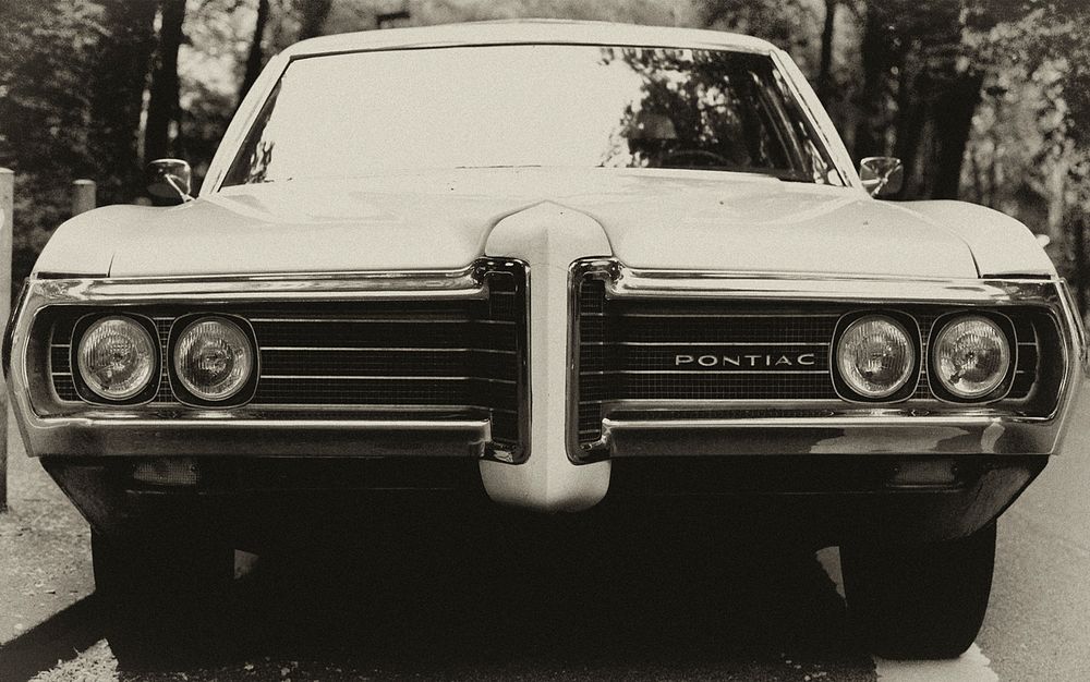 Front view of a vintage Pontiac in black and white.. Original public domain image from Wikimedia Commons