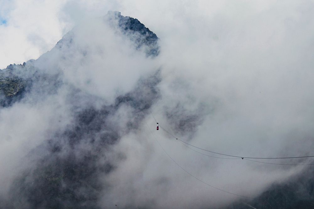 Wires strung through Tatra Mountains on a cloudy, foggy day. Original public domain image from Wikimedia Commons