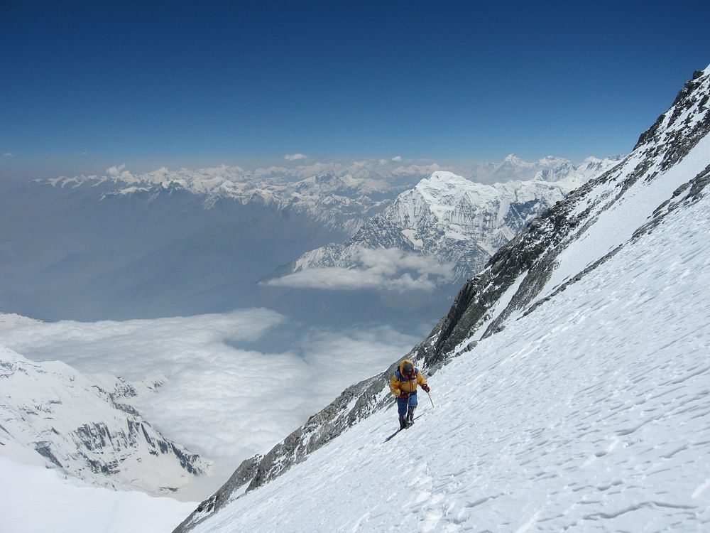 Extreme hiker ascends a snow covered mountain landscape. Original public domain image from Wikimedia Commons