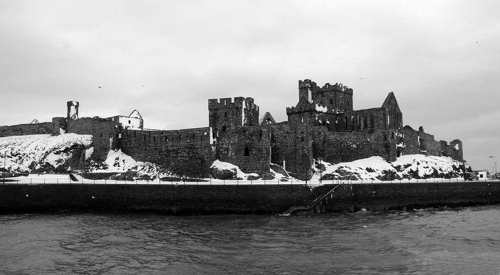 Ancient castle ruins on a winter day surrounded by water. Original public domain image from Wikimedia Commons