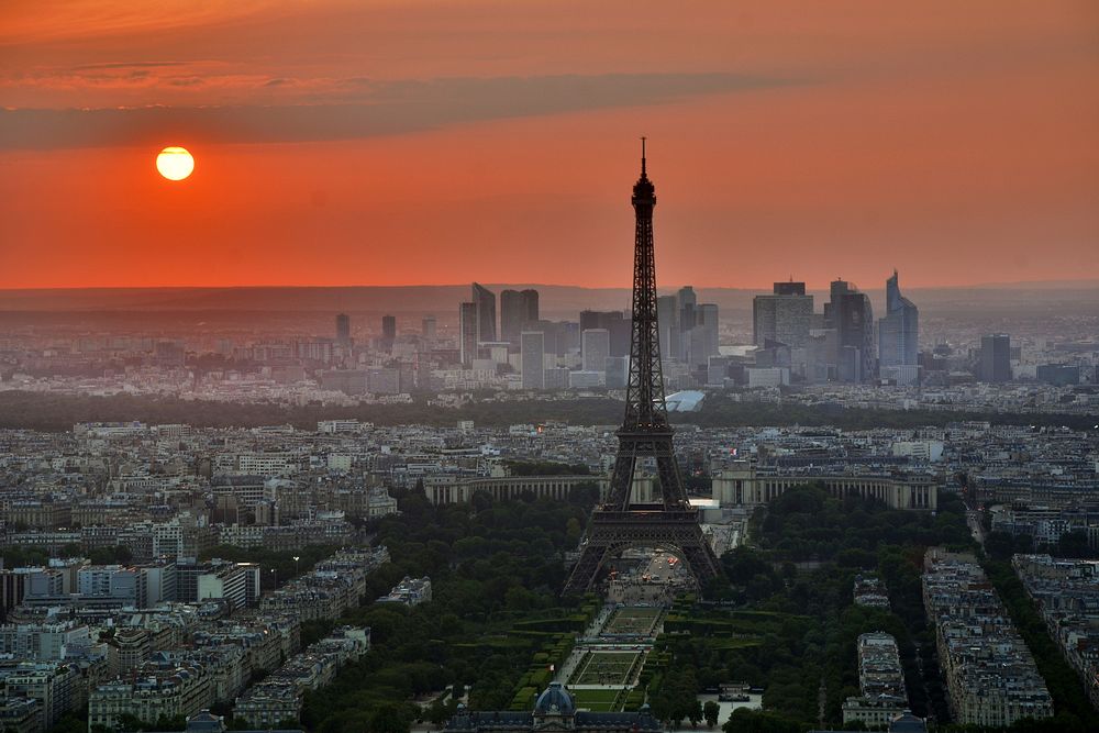 Skyline view of the Eiffel Tower and Paris skyline at sunset with a red sun. Original public domain image from Wikimedia…