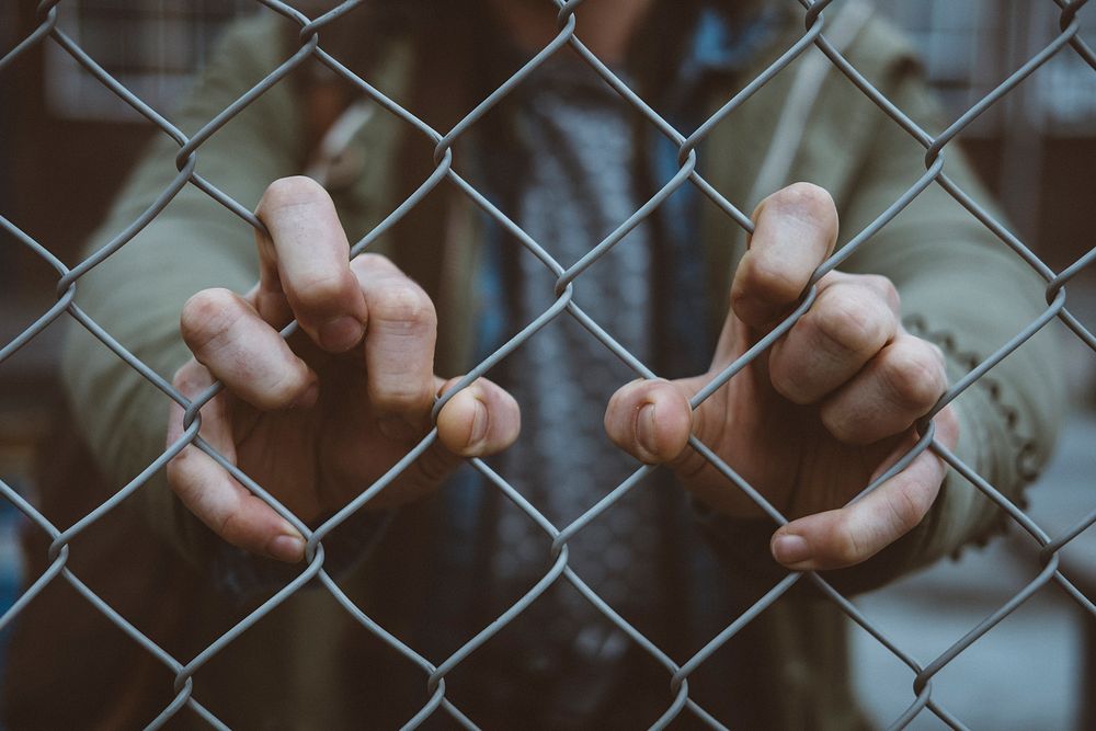 Macro view of an urban person's hand on a chain link fence in De Nieuwe Stad. Original public domain image from Wikimedia…