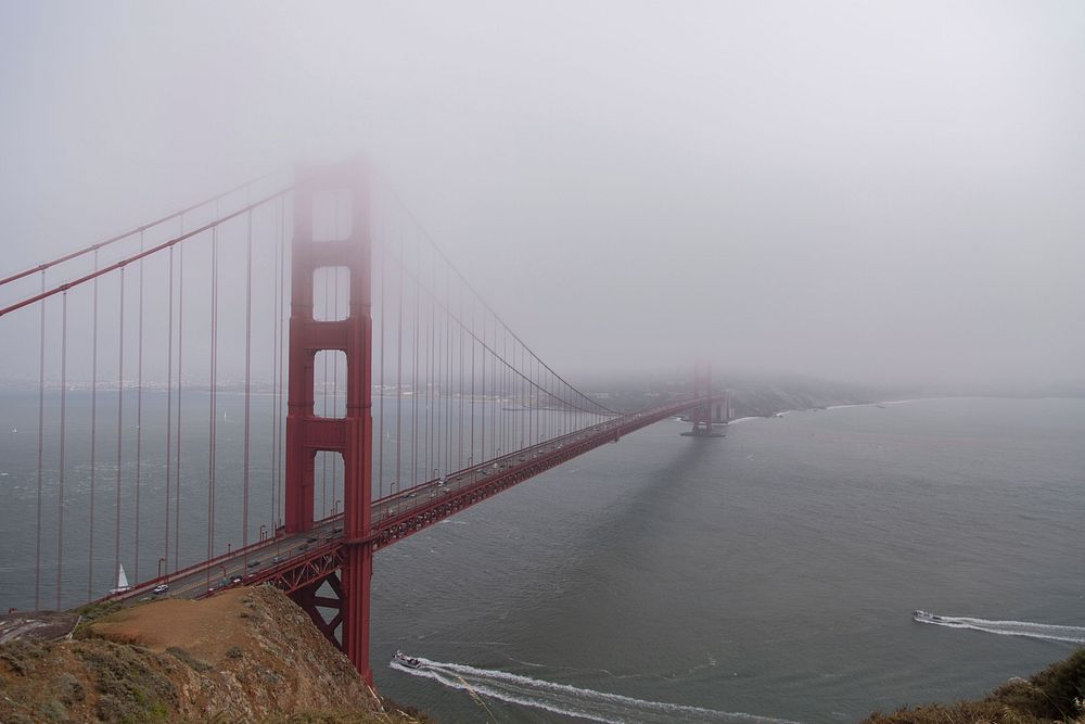 Fog rolls in over the iconic Golden Gate Bridge. Original public domain image from Wikimedia Commons