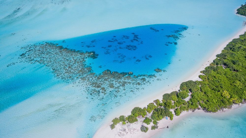 A drone shot of a tropical island in Maldives. Original public domain image from Wikimedia Commons