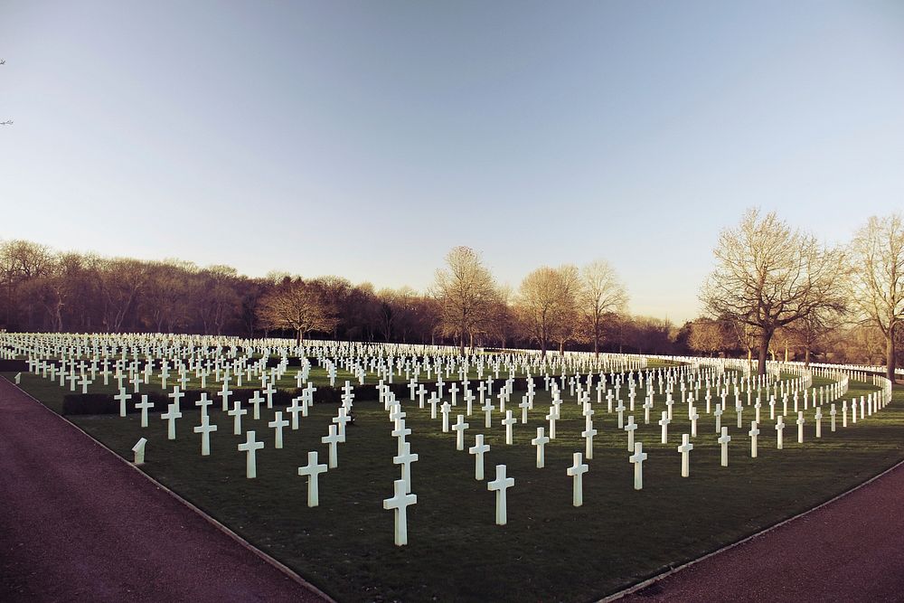 Wide angle shot of a war veteran cemetery filled with white crosses.. Original public domain image from Wikimedia Commons