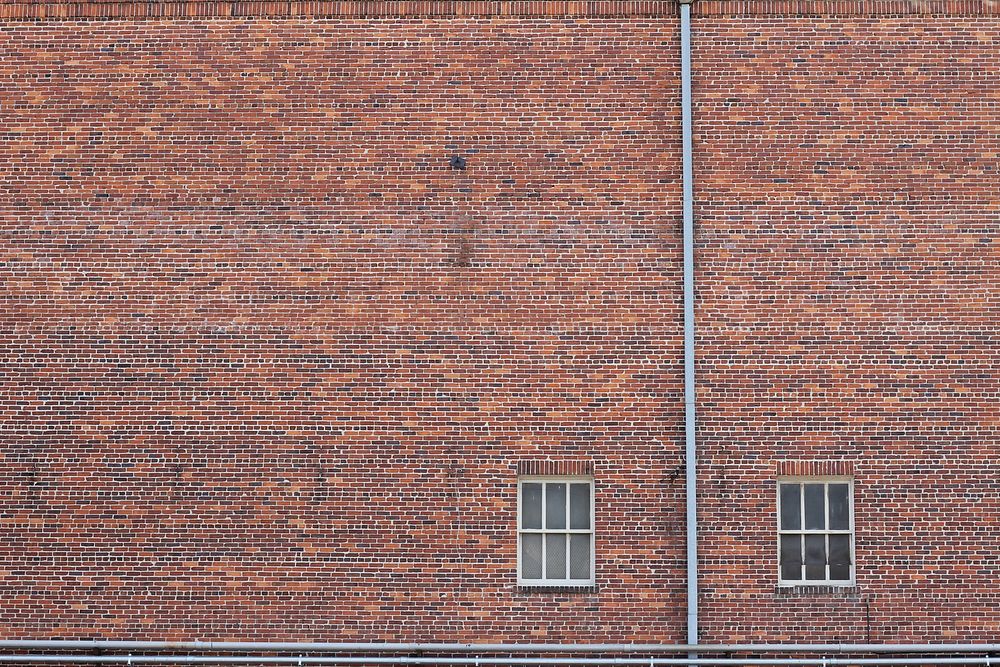 Brickwork and two windows from old building. Original public domain image from Wikimedia Commons