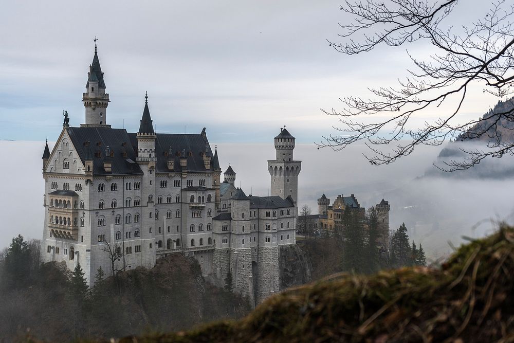 Orante Neuschwanstein Castle surrounded by fog and woods. Original public domain image from Wikimedia Commons