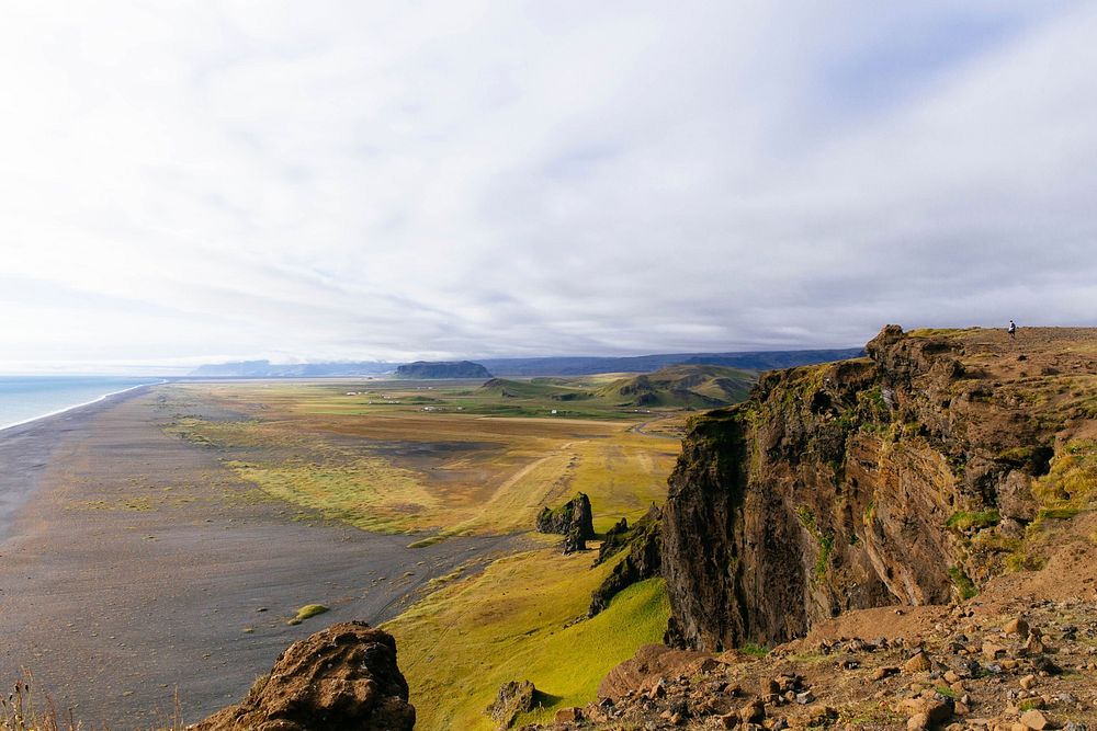 Vast flat coastline by the mountain range at Iceland. Original public domain image from Wikimedia Commons