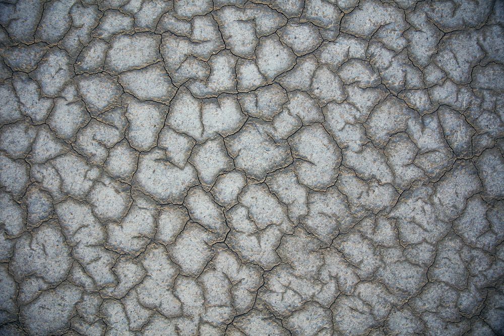 Cracked ground pattern background. Original public domain image from Wikimedia Commons
