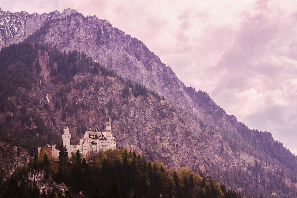 Tall purple-hued mountain towering over Neuschwanstein Castle. Original public domain image from Wikimedia Commons