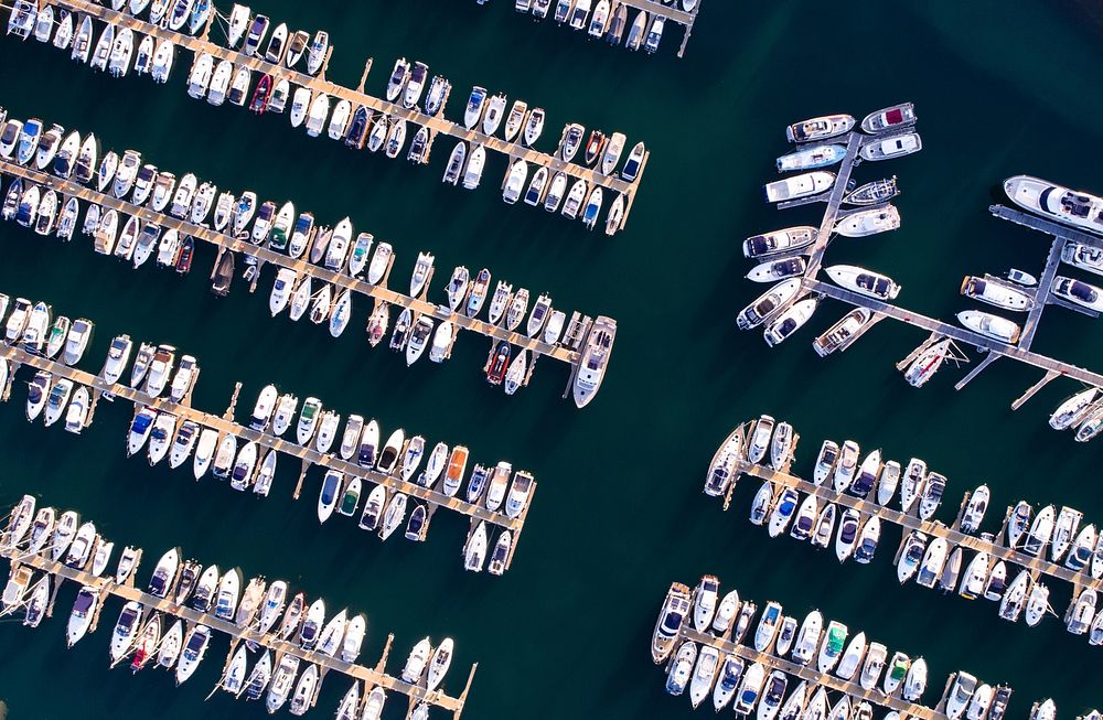 A drone shot of boats moored at a marina. Original public domain image from Wikimedia Commons