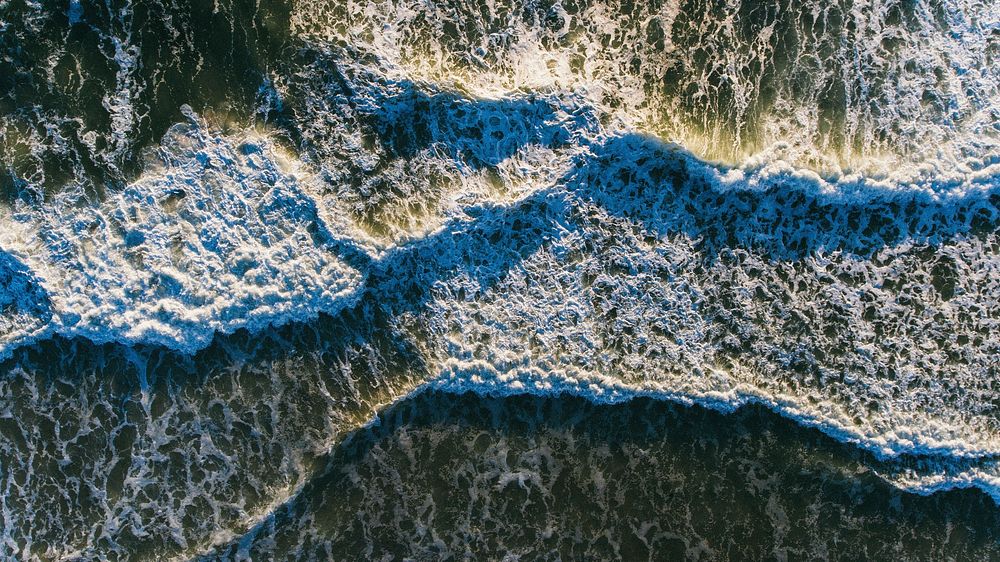Drone view of ocean waves with foam washing on Ponte Vedra Beach, Florida, United States. Original public domain image from…