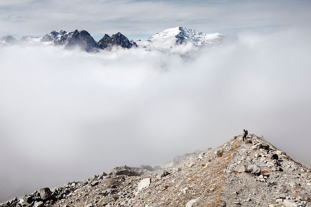 Hiker walks to the summit of a rocky peak in France. Original public domain image from Wikimedia Commons