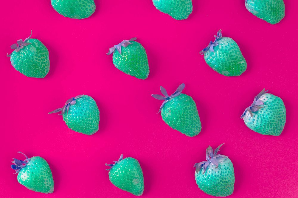 Strawberries with negative filter on pink background