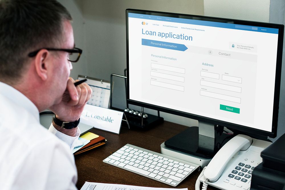 Businessman applying for a loan on a laptop mockup during the coronavirus pandemic