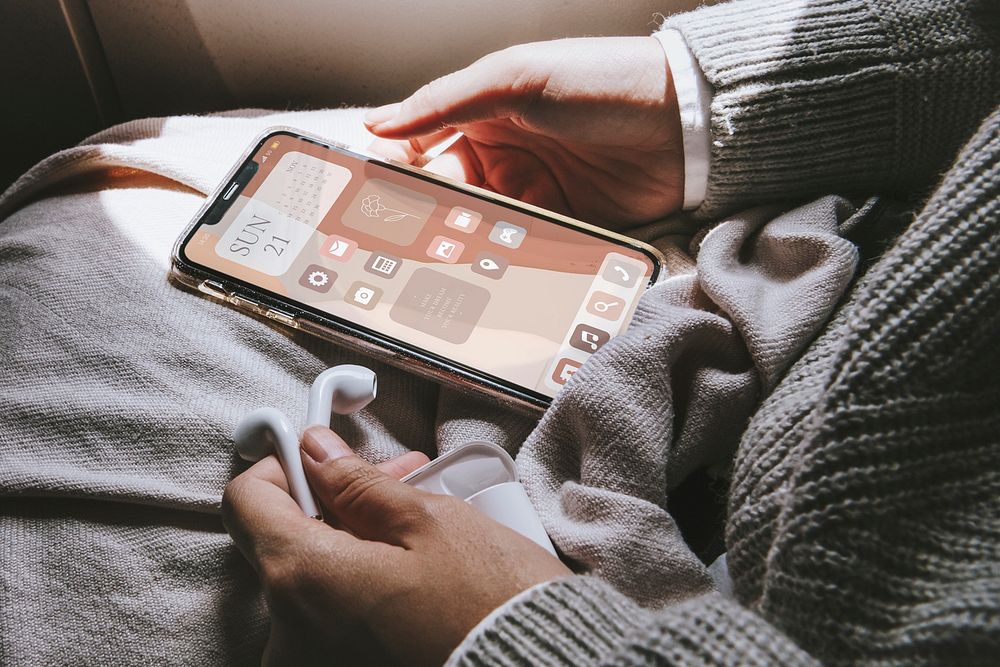 Phone screen mockup psd with hand holding in aesthetic beige widgets