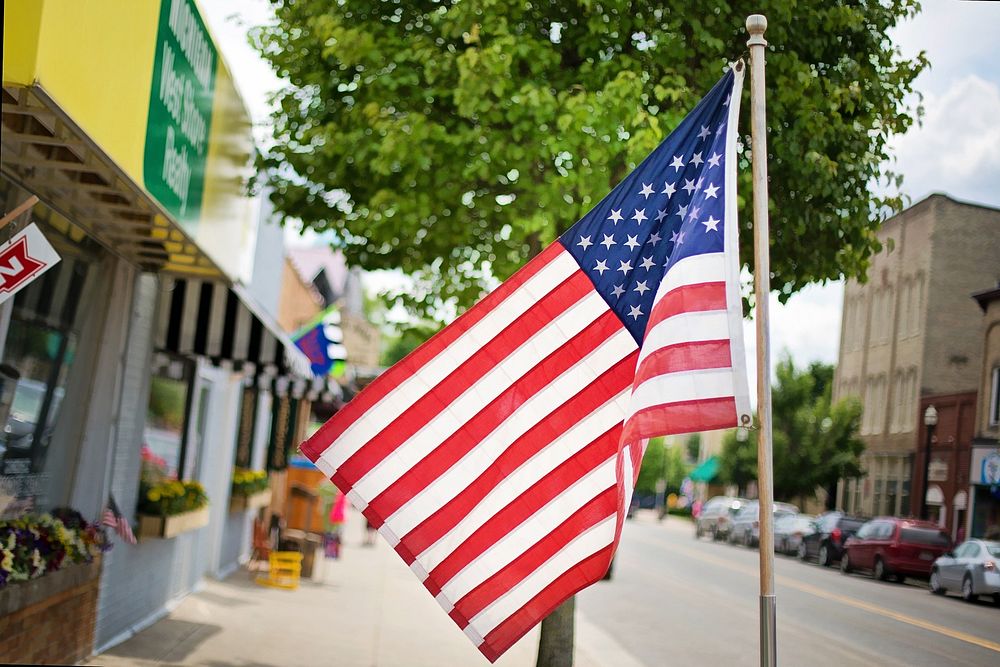 American flag infront of store pavement photo, free public domain CC0 image.