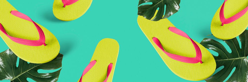 Lime green flip-flops on monstera background