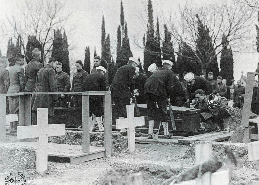 U.S. Embarkation Camp, Pauillac, Gironde, France. Men lowering caskets into graves at the funerals of a soldier and a sailor…