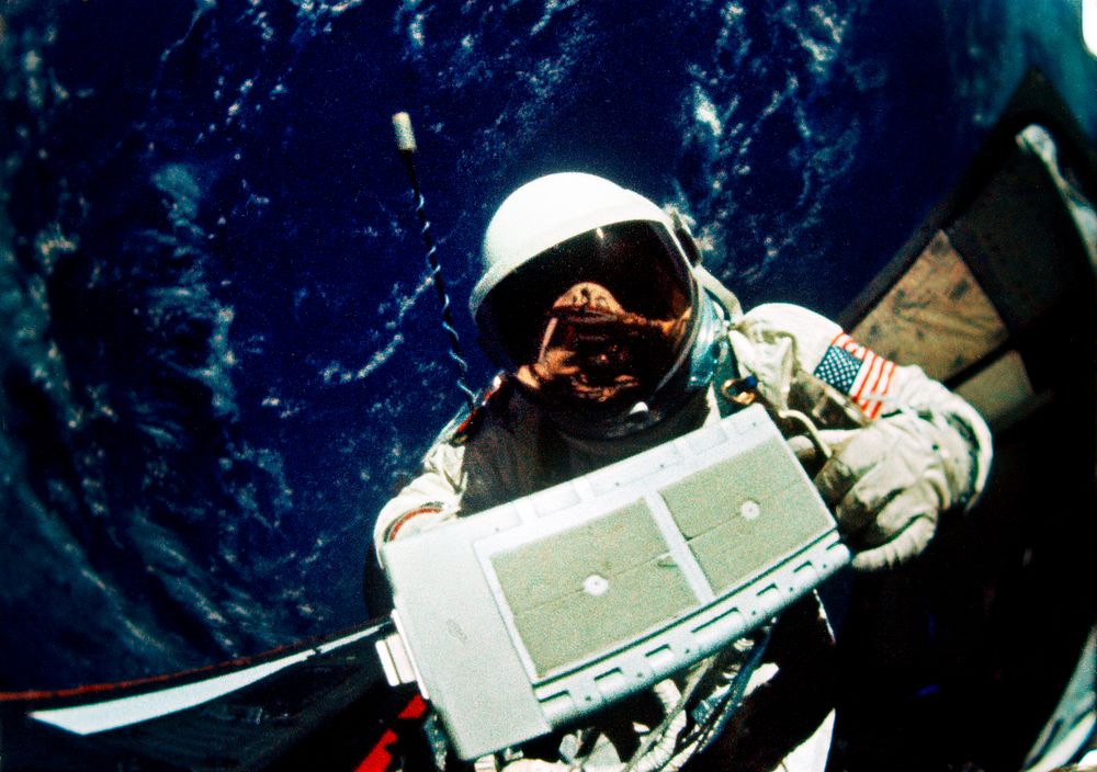 Astronaut Edwin E. Aldrin Jr., pilot for the Gemini-12 spaceflight, removes micrometeoroid package for return to the…