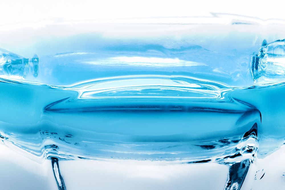 Transparent liquid in a glass background image