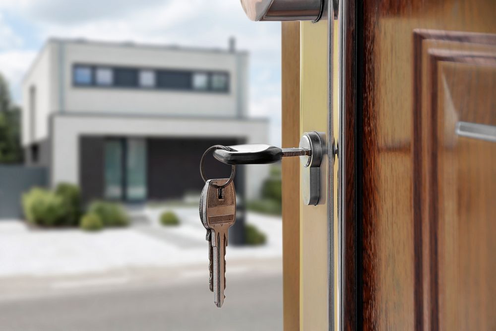 First home purchase, key hanging on door lock, real estate concept