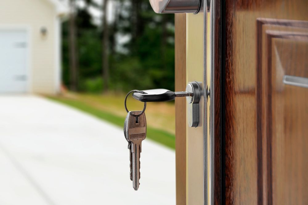 First home purchase, key hanging on door lock, real estate concept psd