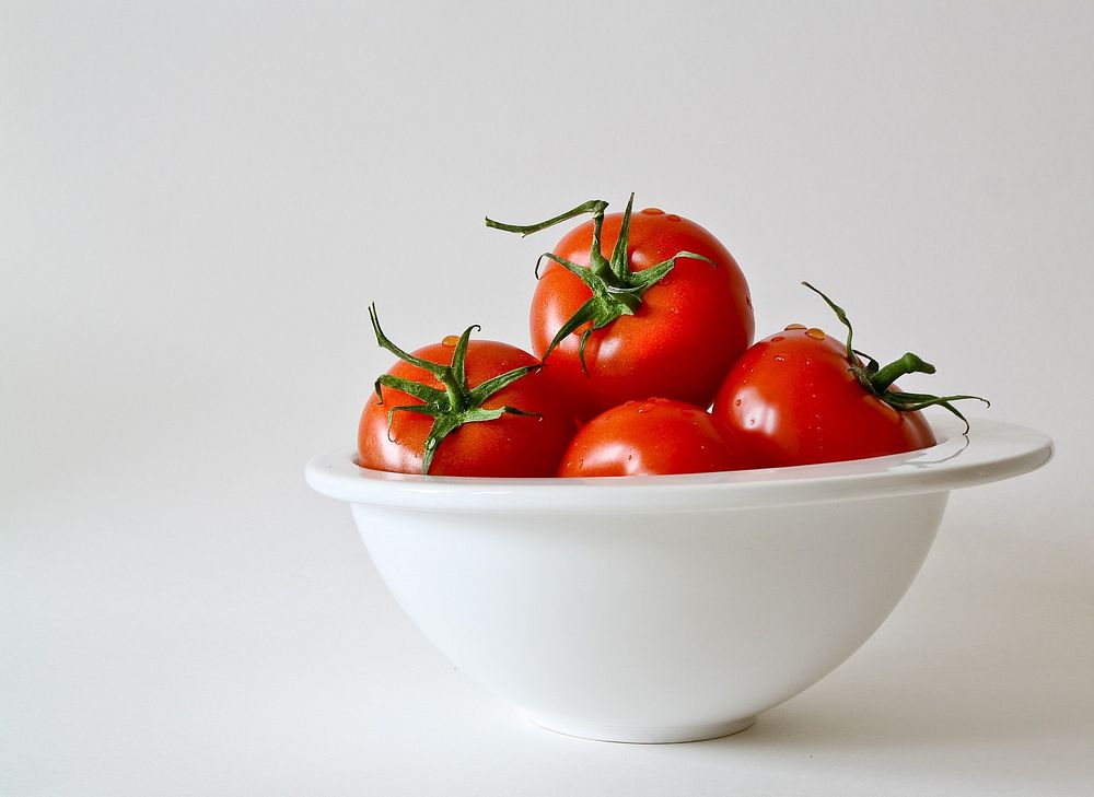 Free image of red tomatoes in a white bowl, public domain CC0 photo.