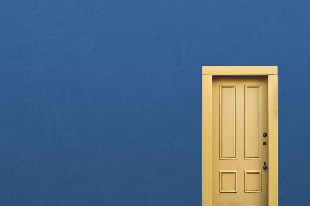 Blue wall background, yellow panel door, home interior