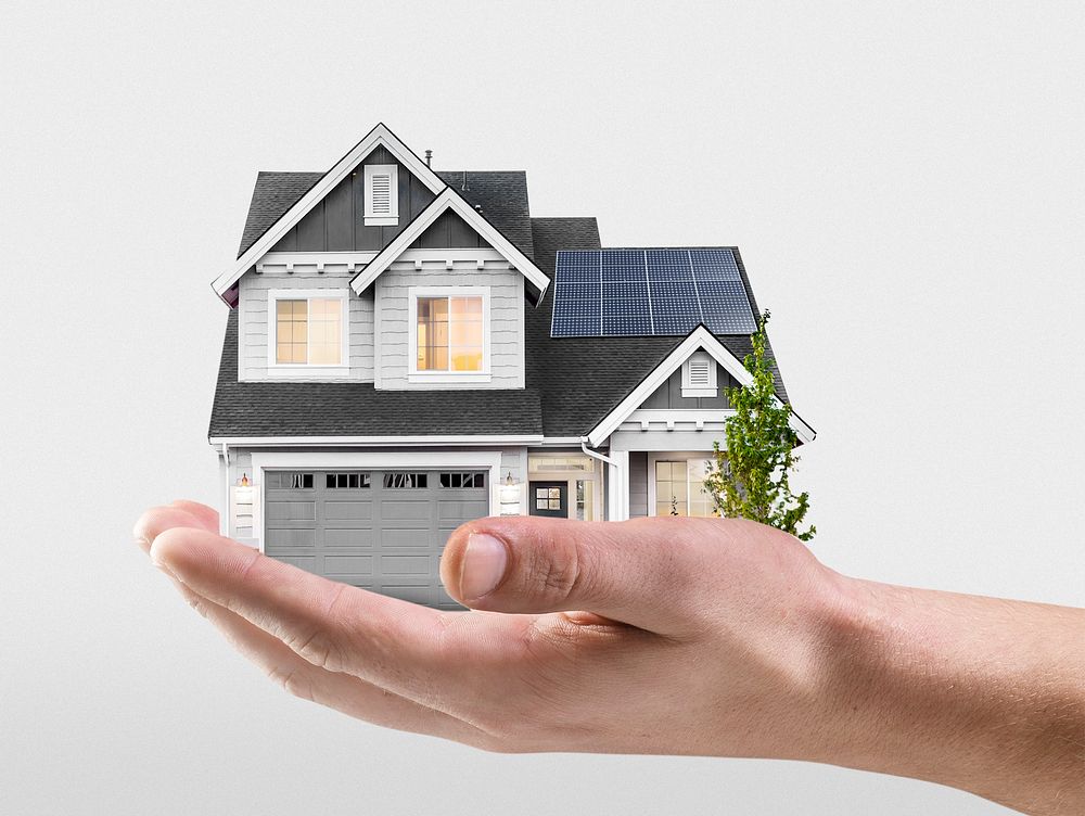 Hand presenting solar-powered house, home loan campaign