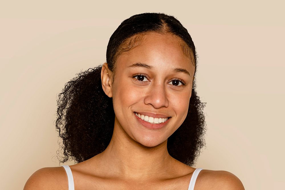 African American young woman portrait, beige background