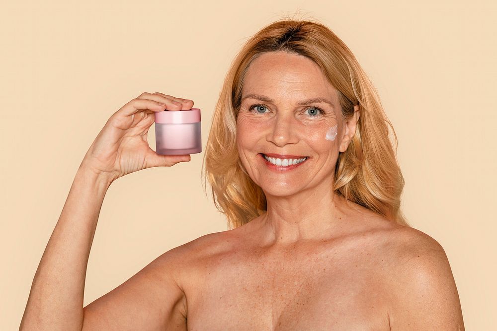 Mature woman holding anti aging cream 