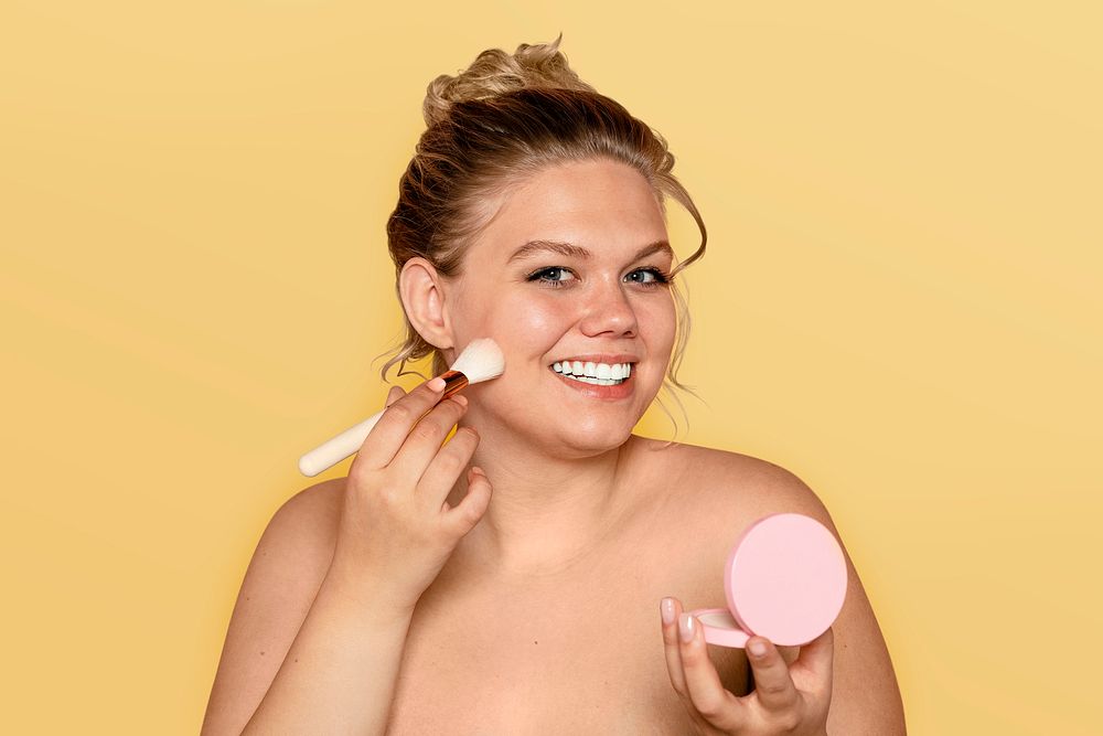 Woman applying blush, makeup & cosmetics psd