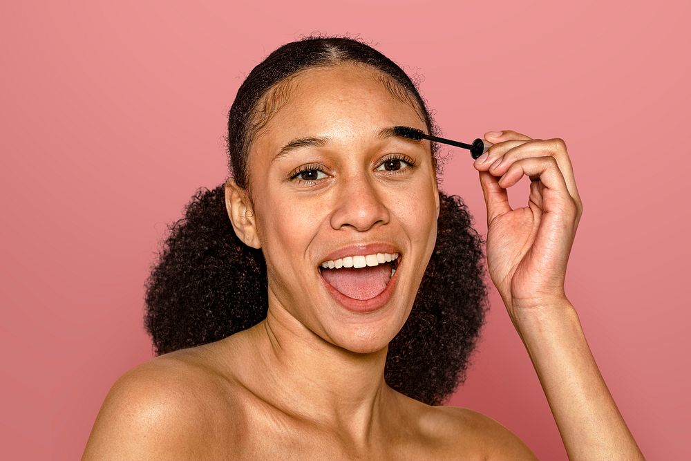Woman using eyebrow brush, beauty & skincare routine psd