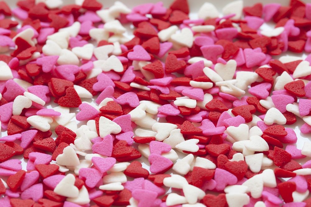 Pink, red and white coloured heart shaped sprinkles. Original public domain image from Wikimedia Commons
