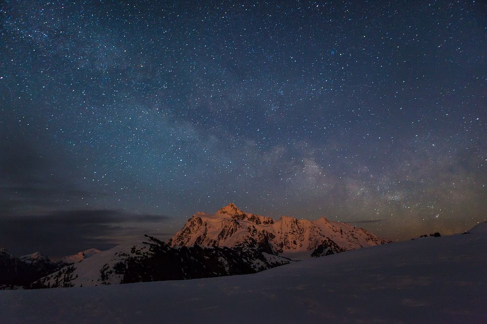 Starry sky over snowy mountain. Original public domain image from Wikimedia Commons