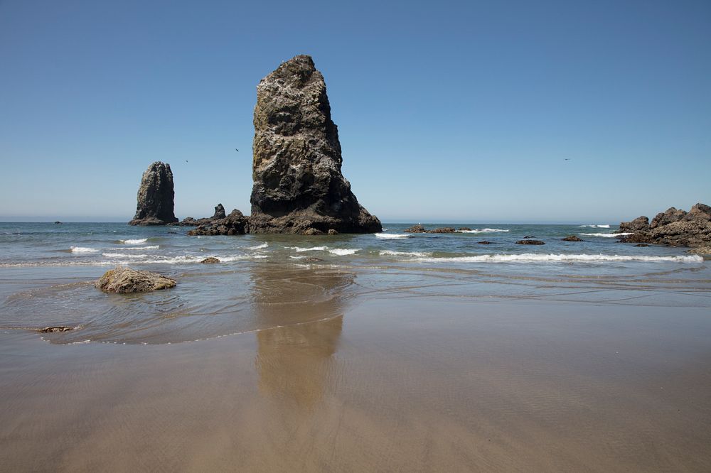 Tidal rock columns known as "sea stacks," off Cannon Beach on the Oregon Coast of the Pacific Ocean.