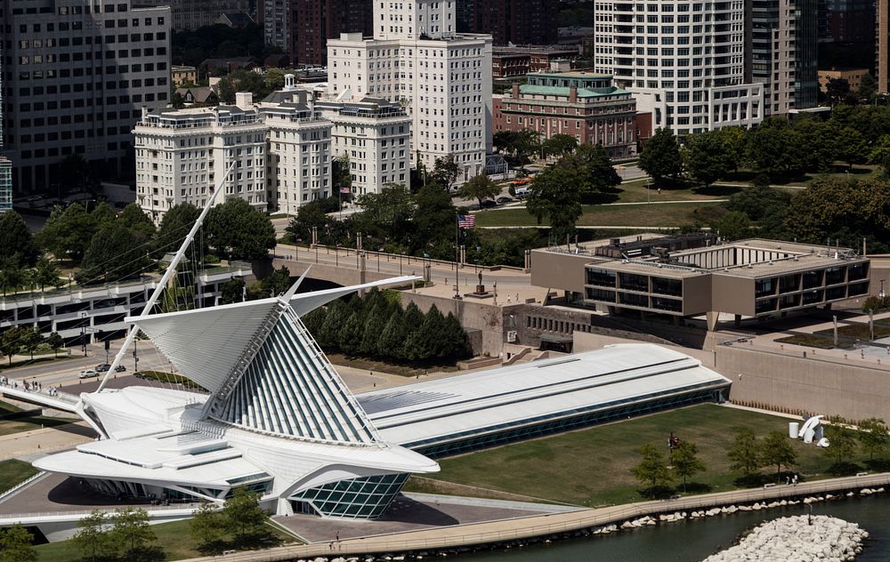 Aerial view of downtown Milwaukee, Wisconsin, focusing on the Milwaukee Art Museum's signature Quadracci Pavilion, designed…