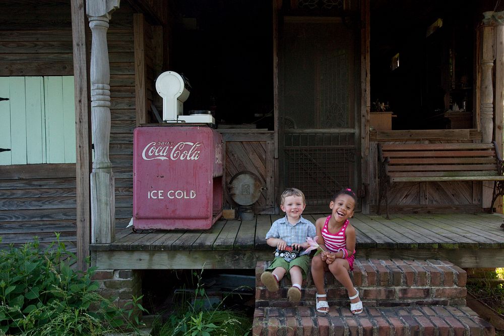 Walter Frederick Anderson, age 1 and Saleah Rose Bruinton, Age 2 pose on the steps of a historic cabin in rural Alabama.