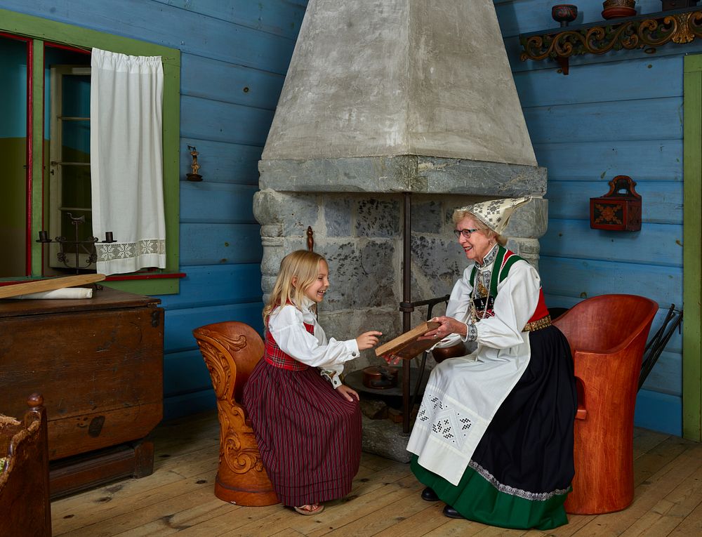 Helen Hendrickson shows an old Norwegian book to Margret Zook at Vesterheim, the Norwegian-American museum and heritage…