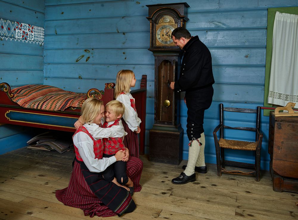 People in traditional Norwegian clothing gather in an exhibit space at Vesterheim, the Norwegian-American museum and…