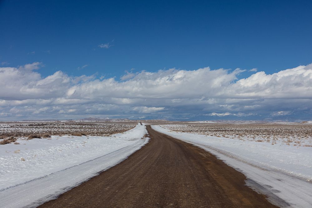 Rural road through rugged and remote Sweetwater County, Wyoming in wintertime.