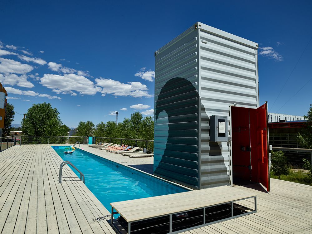 A swimming pool and supply building made of huge shipping containers -- the kind piled high on seagoing vessels -- in the…