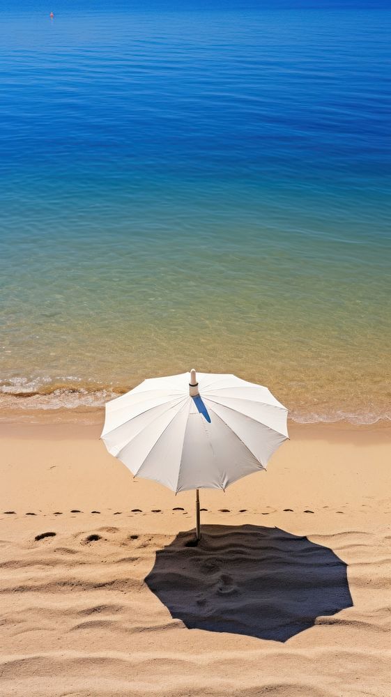 Umbrella on a beach summer water shoreline.